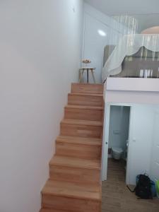 a staircase in a living room with a stair case at ZIL - Studio Apartment City Center in Zagreb