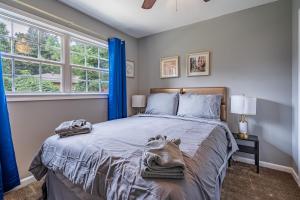 a bedroom with a bed with blue curtains at Homely & Alluring 5 bedrooms in Atlanta! in Atlanta