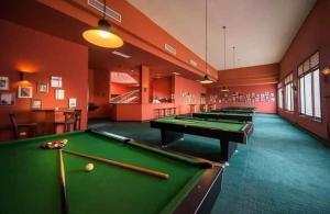 a row of pool tables in a billiard room at قرية بالميرا السخنه in Ain Sokhna