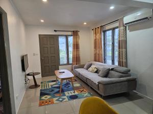 a living room with a couch and a table at FIJI HOME Apartment Hotel in Suva