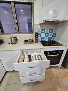 a kitchen with a white drawer with eggs in it at FIJI HOME Apartment Hotel in Suva