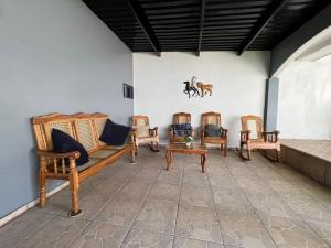 a room filled with wooden furniture on a wall at Cuco Beach Paradise Villa in Chirilagua