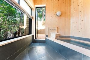 a swimming pool in a house with a window at プライベートリゾート犬の日 in Hakone