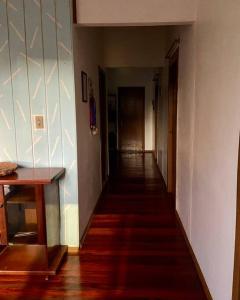 a hallway of a house with a long hallway at Quarto casa Guaporé in Guaporé