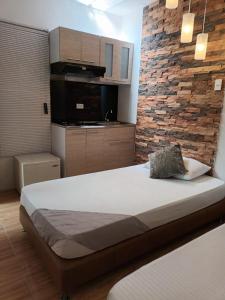 Rúm í herbergi á Hotel Coffee Real Pereira