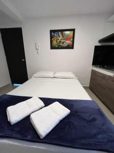 Rúm í herbergi á Hotel Coffee Real Pereira