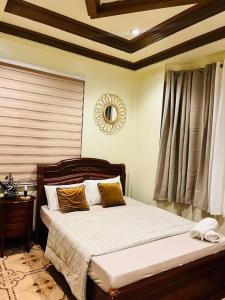 a bedroom with a bed and a mirror on the wall at City Villa in Tagbilaran City