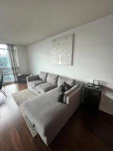 uma sala de estar com um sofá e uma mesa em Downtown Toronto Suite By The Lake em Toronto