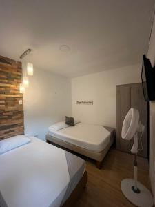 Rúm í herbergi á Hotel Coffee Real Pereira