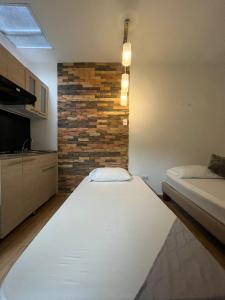 Rúm í herbergi á Hotel Coffee Real Pereira