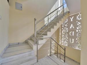 a set of stairs with a metal railing at OYO Flagship Hotel Hastinapur Residency in Jaipur
