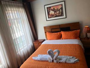 Rúm í herbergi á Tambo Cusco Inn