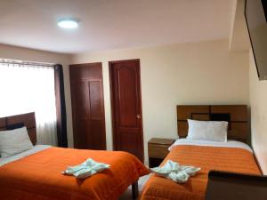 Rúm í herbergi á Tambo Cusco Inn