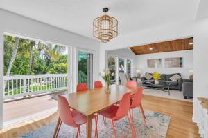 a dining room and living room with a table and chairs at Luxury getaway steps from beach sleeps 10 in Siesta Key