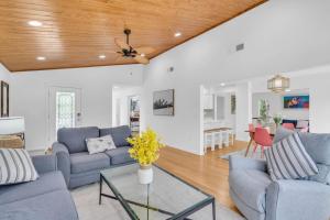a living room with blue couches and a wooden ceiling at Luxury getaway steps from beach sleeps 10 in Siesta Key