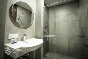 a bathroom with a sink and a mirror at K Avenue by Pinstay in Donggongon
