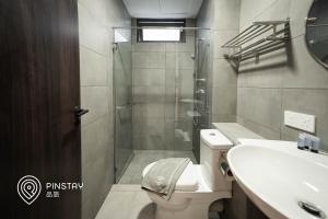 a bathroom with a shower and a toilet and a sink at K Avenue by Pinstay in Donggongon