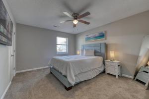 a bedroom with a bed and a ceiling fan at 1408 Perrin Dr, Unit B - Ocean Walk Sleeps 8 in Myrtle Beach