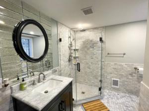 a bathroom with a sink and a shower with a mirror at Renovated Studio, Near Hospitals, Mbta in Boston