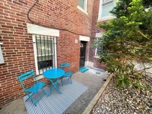 a blue table and chairs in front of a brick building at Renovated Studio, Near Hospitals, Mbta in Boston