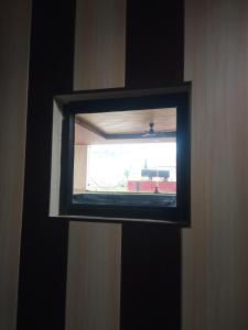 a window in a room with a view of a train at Haridwar and kedarnath dharmshala in Haridwār