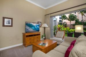 a living room with a couch and a tv at KBM Resorts: Honua Kai HKH-114 1Bd w Rental Car in Kaanapali
