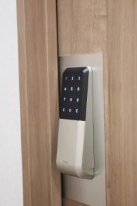 a close up of a remote control on a door at OHWA hostel minowa station in Tokyo