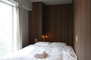 Postel nebo postele na pokoji v ubytování OHWA hostel minowa station