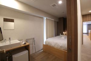 Postel nebo postele na pokoji v ubytování OHWA hostel minowa station