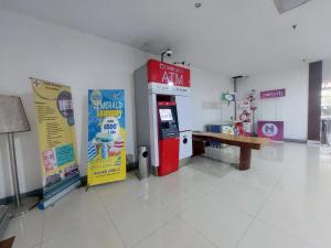a gas station with a soda machine in a room at Emerald Apartel in Bandung