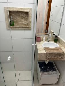 a bathroom with a sink and a shower at Conforto e aconchego in Poços de Caldas