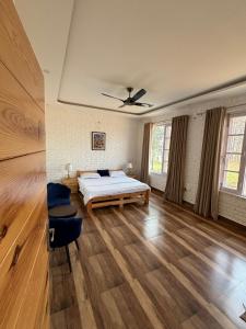 a large room with a bed and a ceiling at Hibiscus in Kota Bāgh