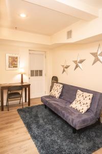a living room with a purple couch and stars on the wall at Multi-level Townhouse, Harvard, Mit, Red Line in Cambridge