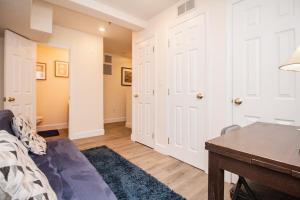 a room with a bed and a desk and a door at Multi-level Townhouse, Harvard, Mit, Red Line in Cambridge