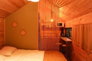 a bedroom with a bed and a desk in a room at Jvarisa Glamping in Ambrolauri +29 photos