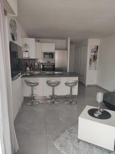 a kitchen with a counter and stools in it at Studio Cap d'Agde in Cap d'Agde