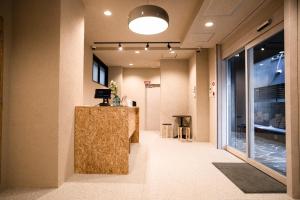 a lobby with a reception desk in a building at Wayfarer Kyoto Shijo in Kyoto