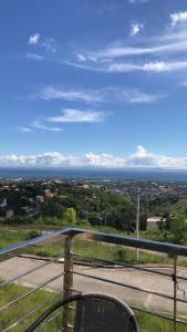 a chair sitting on a balcony with a view of a city at The Stunning Views here are beyond description ! in Candulawan