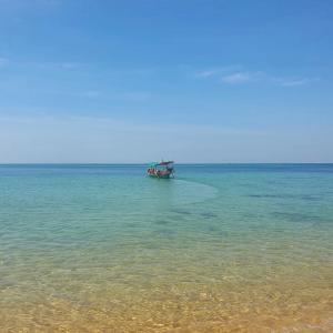 a boat in the middle of the ocean at KAMAKU Bungalows in Koh Rong Sanloem