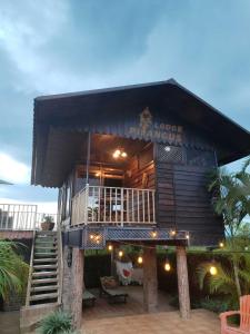 a large building with a porch and a deck at Pitangus Lodge in Chachagua