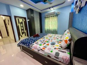 a bedroom with a bed in a blue room at Beautiful 2bhk near Begumpet in Hyderabad