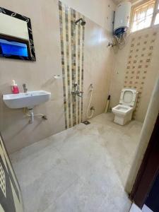 a bathroom with a sink and a toilet at Beautiful 2bhk near Begumpet in Hyderabad