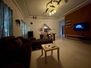 a living room with a couch and a coffee table at Beautiful 2bhk near Begumpet in Hyderabad