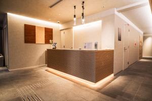 a lobby with a reception desk in a building at ORI Kyoto in Kyoto