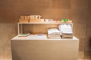 a shelf with towels and other items on it at ORI Kyoto in Kyoto