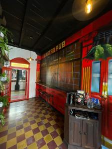 a dining room with a burger pub sign on the wall at The Hostal Pub Antigua Guatemala in Antigua Guatemala