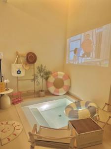 a living room with a swimming pool and a tv at Jeju Homestay in Hue