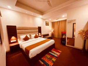 a hotel room with a large bed in a room at Olive Tree Resort, Haridwar in Haridwār