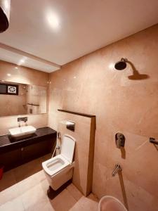 a bathroom with a toilet and a sink at Olive Tree Resort, Haridwar in Haridwār