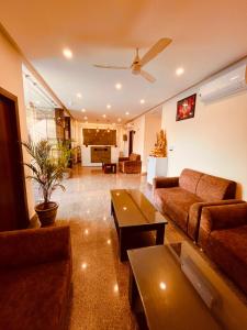 a living room with a couch and a table at Olive Tree Resort, Haridwar in Haridwār